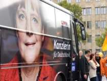 Merkel castiga alegerile, dar...